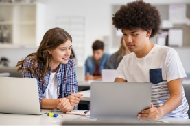 male and female student work together